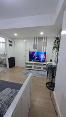 a living room with a flat screen tv on a wall at AZURE BICUTAN MAUI G14 TOWER POOL View in Manila