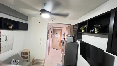 a room with a kitchen with a ceiling fan at STARR 2050 Vacation Home in Manila