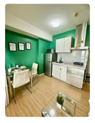 a kitchen with green walls and a table and a dining room at 400MBPS! 3Beds 1217 Azure Urban Beach Spa Mall Resto in Manila