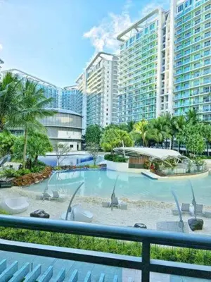 a large swimming pool in front of a large building at Azure Urban Resort Residences in Manila