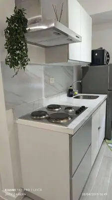 a white kitchen with a stove top oven at AZURE BICUTAN BORACAY 4FL BEACH POOL View in Manila