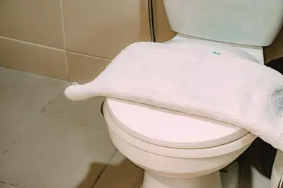 a towel is sitting on a toilet in a bathroom at I Suites Hotel Malate in Malate