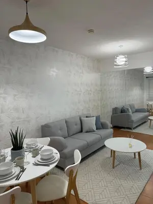 a living room with a couch and a table at Modern Minimalist Luxe Retreat 2 Bedroom with parking in Manila