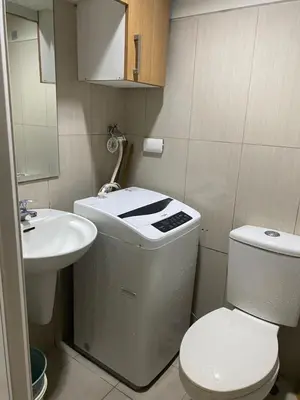 a small bathroom with a toilet and a sink at Sebby's staycation at Shell MOA in Manila