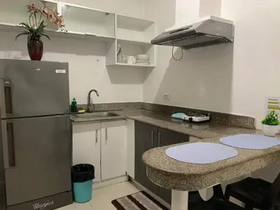 a kitchen with a counter and a sink and a refrigerator at Birch Tower A8 Front of Robinson Mla BayFree Pool in Manila