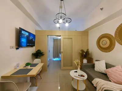 a living room with a couch and a table at 1BR Condotel with Balcony at SM Light Residences #LT02-1 in Manila