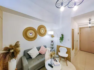 a living room with a couch and a chair at 1BR Condotel with Balcony at SM Light Residences #LT02-1 in Manila