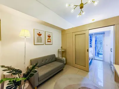 a living room with a couch and a table at 1BR Condotel with Balcony at SM Light Residences #LT03-1 in Manila