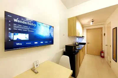 a kitchen with a large flat screen tv on a wall at 1BR Condotel with Balcony at SM Light Residences #LT05-1 in Manila