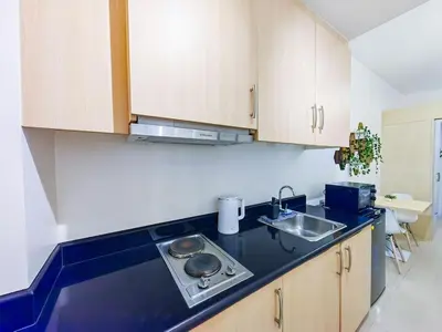 a kitchen with a sink and a counter top at 1BR Condotel with Balcony at SM Light Residences #LT06-1 in Manila