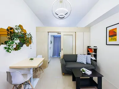 a living room with a couch and a table at 1BR Condotel with Balcony at SM Light Residences #LT06-1 in Manila