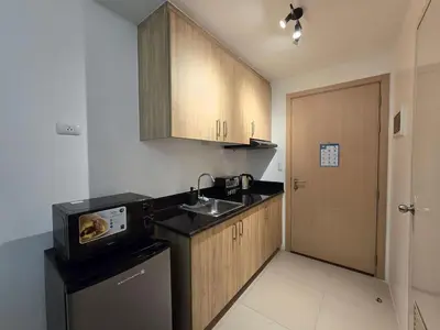 a small kitchen with a sink and a dishwasher at 1BR Condotel with Balcony at SM Light Residences #LT07-1 in Manila