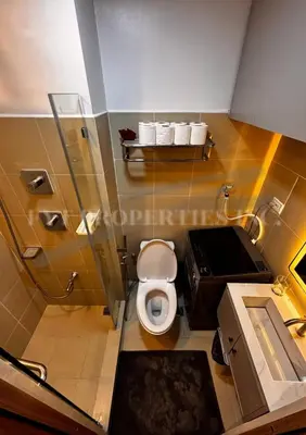 a small bathroom with a toilet and a sink at Lux Staycation at Shore 3, MOA in Manila