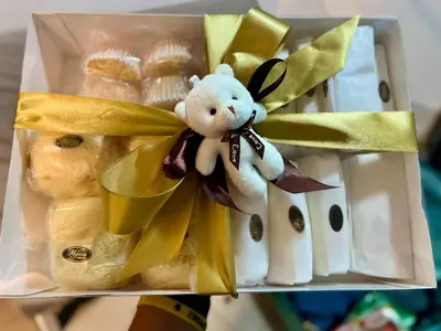 a gift box with a teddy bear in it at STARR VACATION Condo in Manila