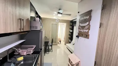 a kitchen with a sink and a refrigerator at STARR VACATION Condo in Manila