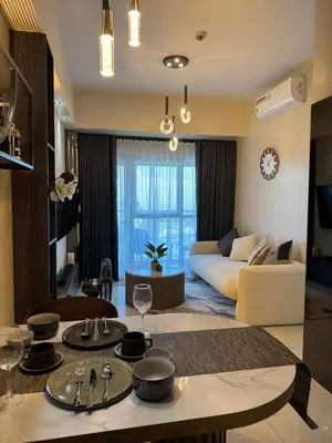 a living room with a couch and a table at Landscape view and sea view 1BR near Airport in Manila