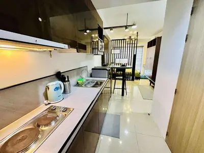 a kitchen with two sinks and a counter top at Minimalist Urban Loft in Manila