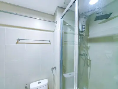 a bathroom with a glass shower and a toilet at 1BR Condotel with Balcony at FAME Residences #FM09-1 in Manila