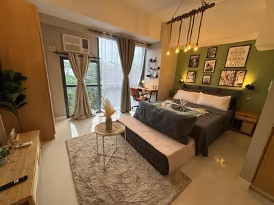a living room with a bed and a couch at Netflix and WiFi Staycation Viceroy Walk to Venice Grand Canal in Manila