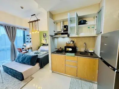 a small kitchen with a sink and a bed in a room at Netflix and WiFi Staycation Viceroy Walk to Venice Grand Canal in Manila