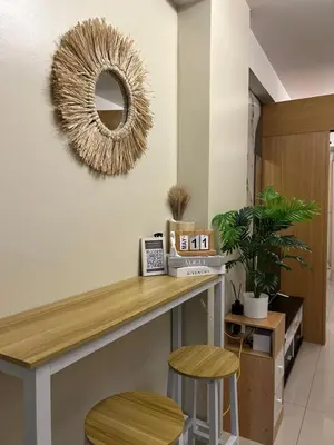 a dressing room with a table and two stools at Vista gracia staycation in Manila