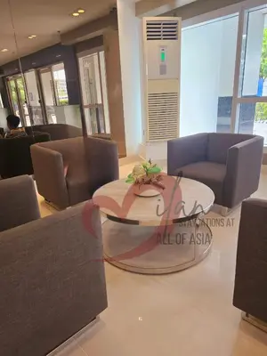 a living room with a table and chairs in a room at Mall of Asia Sea Residences- Milan Staycations Casa Juan in Manila