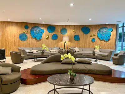 a living room with a large bed and couches at MOA Condotel in Mall of Asia located in Shore1 and 2 Residences in Manila