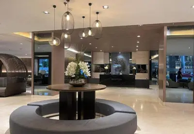 a lobby with a table with flowers on it at Mall of Asia Condohotel located in Shore Residences Pasay in Manila