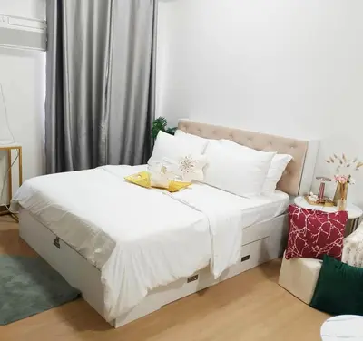 a bedroom with a bed with white sheets and white pillows at LuxeInn in Trece Martires