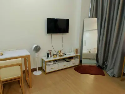 a living room with a television on the wall at LuxeInn in Trece Martires