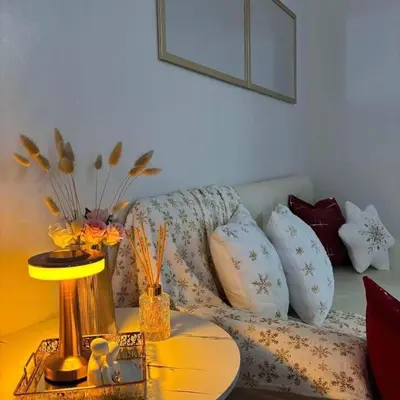 a living room with a couch with pillows and a table at LuxeInn in Trece Martires
