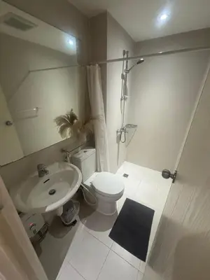 a bathroom with a white toilet and a sink at 1BR Condotel in Azure Urban Resort Near NAIA #TRO3 in Manila