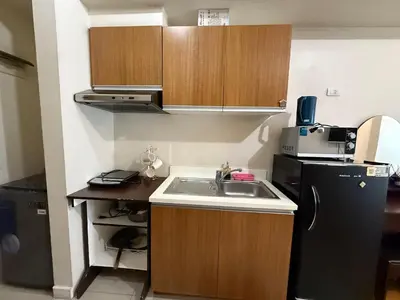 a small kitchen with a sink and a refrigerator at 8 Adriatico Manila in Manila
