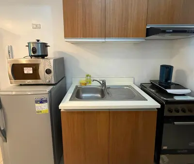 a small kitchen with a sink and a microwave at 8 Adriatico Manila in Manila