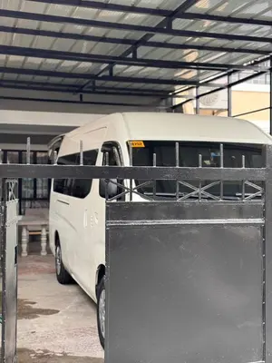 a white van parked in a parking lot at 4BR Townhouse w Garage, Peaceful near Restaurants in Manila
