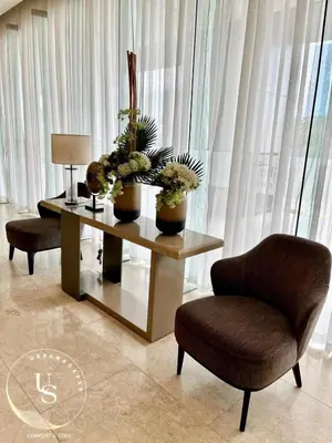 a living room with a table and two chairs at Mall of Asia condotel shore 3 residence in Manila