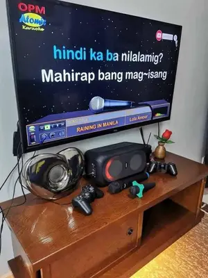 a tv sitting on top of a wooden table at Mall of Asia condotel shore 3 residence in Manila