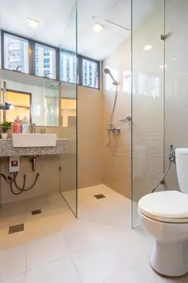 a bathroom with a glass shower and a toilet at Florence Mc Kinley Spacious 2 Bedroom, 2 balcony nr Mall, T3 airport in Manila