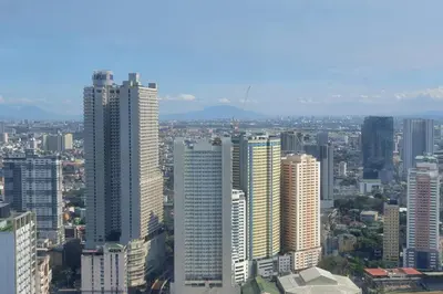 a view of a city with tall buildings at Elevated cozy loft studio in Manila