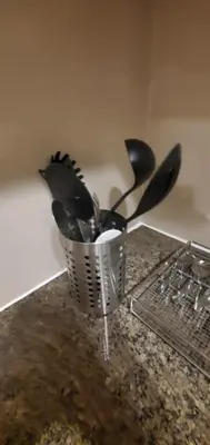 a group of utensils in a holder on a counter at 81 Newport Studio C5 5i near NAIA T3 Pool and Balcony in Manila