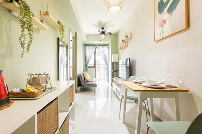 a kitchen with a table and a dining room at Apartment in Pasay, close to Mall Of Asia in Manila