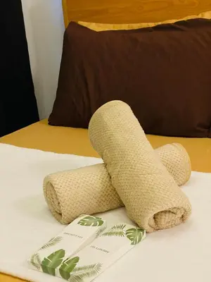 a rolled up towel on top of a bed at Shore Urban Escape in Manila