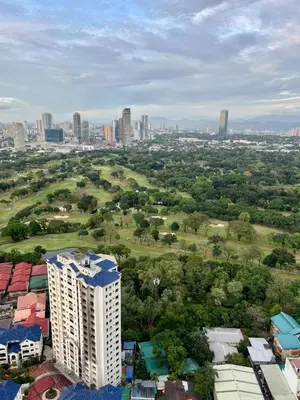 an aerial view of a city with a tall building at High and Cozy Vista Shaw in Manila