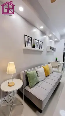 a living room with a couch and a table at Stylish Modern Condo at Shore Residences MOA in Manila