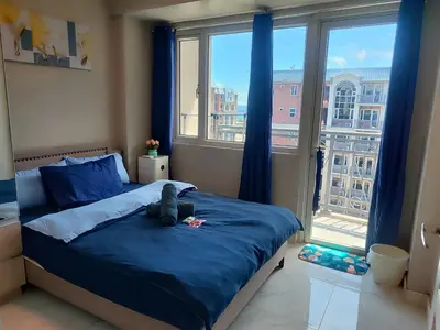 a bedroom with a bed with a teddy bear on it at BP1637 Facing Pool with Balcony near MOA BP1637 in Manila