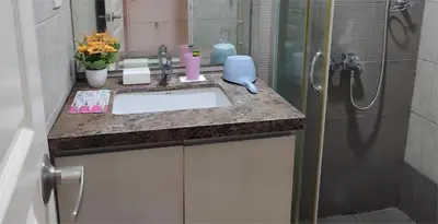 a bathroom with a sink and a shower at BP1637 Facing Pool with Balcony near MOA BP1637 in Manila