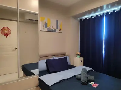 a bedroom with a bed and a large mirror at BP1637 Facing Pool with Balcony near MOA BP1637 in Manila