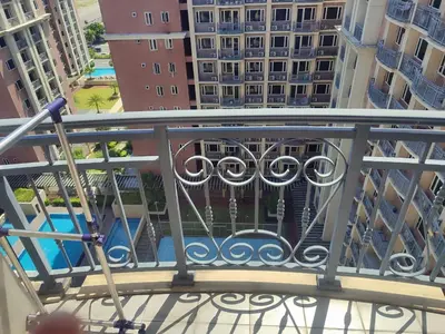 a balcony with a view of a pool and buildings at BP1637 Facing Pool with Balcony near MOA BP1637 in Manila