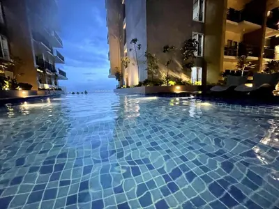 a swimming pool in the middle of a building at Elegant 1BR near Solaire, Okada, Mall of Asia in Manila