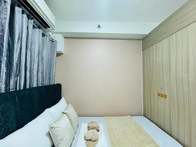 a bedroom with a bed with a teddy bear on it at Shore 2 Residences Room 360 POOL VIEW by Prime Stay MOA in Manila